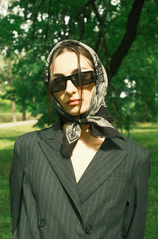 Woman in black coat with sunglasses